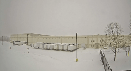 Snow and ice accumulation across a distribution center parking lot and dock approach